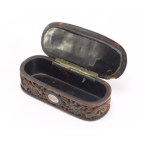 634 - Chinese Canton tortoiseshell snuff box having a hinged lid and inset silver cartouche, carved with d... 