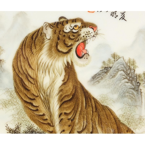 627 - Chinese porcelain plate finely hand painted with a snow tiger before a mountain landscape with calli... 