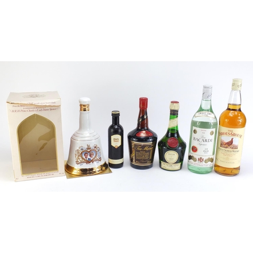 864 - Six bottles of alcohol including 1L Famous Grouse whiskey, vintage 1L Bacardi and Bells Prince Charl... 