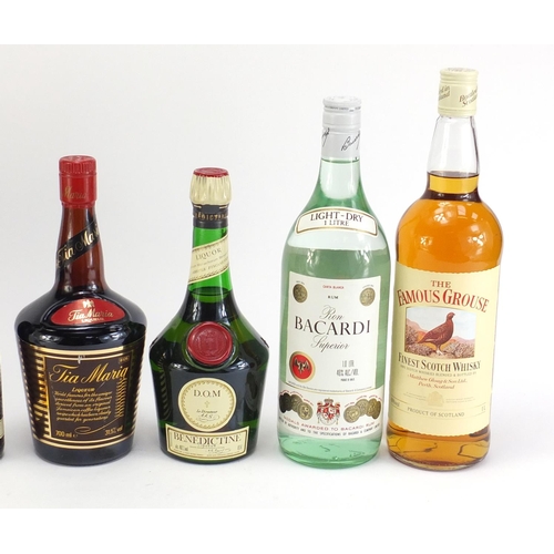 864 - Six bottles of alcohol including 1L Famous Grouse whiskey, vintage 1L Bacardi and Bells Prince Charl... 