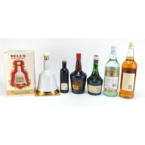 864 - Six bottles of alcohol including 1L Famous Grouse whiskey, vintage 1L Bacardi and Bells Prince Charl... 