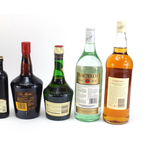 864 - Six bottles of alcohol including 1L Famous Grouse whiskey, vintage 1L Bacardi and Bells Prince Charl... 