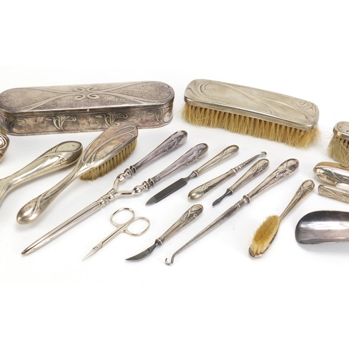 184 - Art Nouveau silver plated vanity metalware, including hand mirror, brushes and hair curlers each imp... 