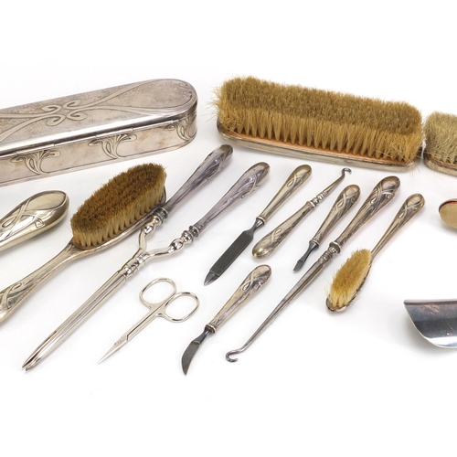 184 - Art Nouveau silver plated vanity metalware, including hand mirror, brushes and hair curlers each imp... 