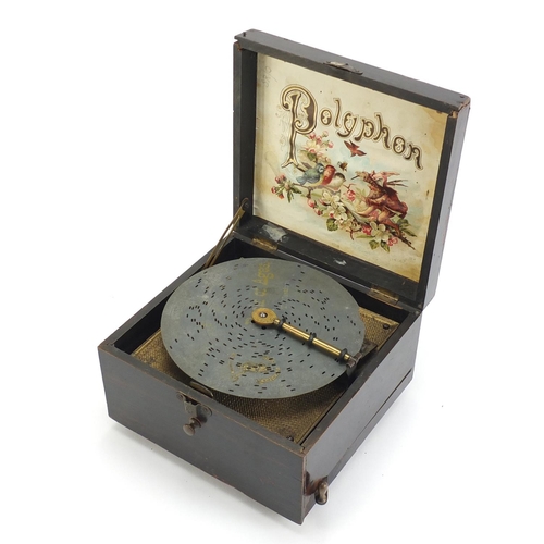 85 - Wooden cased 6 inch polyphone music box with fifteen discs, the top with hand painted floral pattern... 