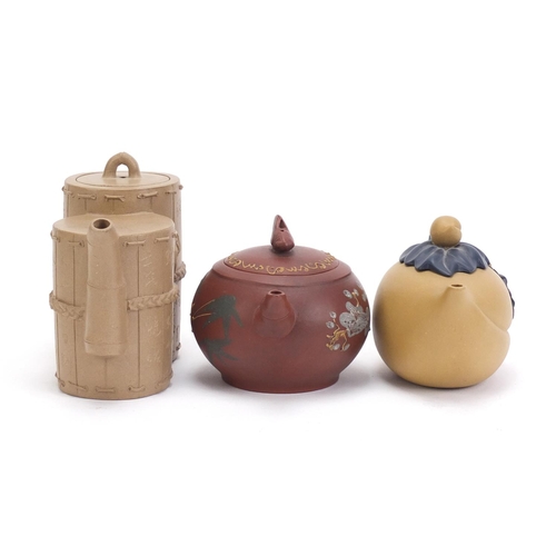 835 - Three Chinese Yixing teracotta teapots including one in the form of a yellow peach and another hand ... 