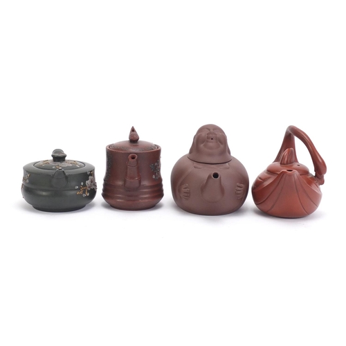 228 - Four Chinese Yixing teracotta teapots comprising one in the form of a smiling Buddha, another in the... 