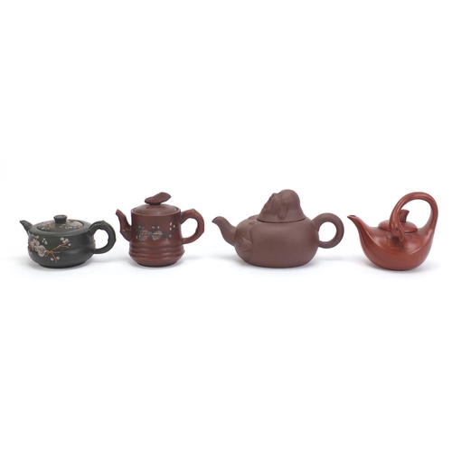 228 - Four Chinese Yixing teracotta teapots comprising one in the form of a smiling Buddha, another in the... 