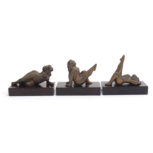 250 - Three South African bronze sculptures of nude females raised on a rectangular wood bases by Jean Doy... 