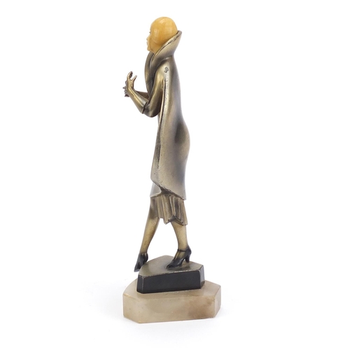 157 - Art Deco bronzed figure of a female with carved ivory head, raised on a shaped onyx base, 25cm high