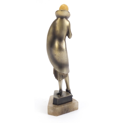 157 - Art Deco bronzed figure of a female with carved ivory head, raised on a shaped onyx base, 25cm high