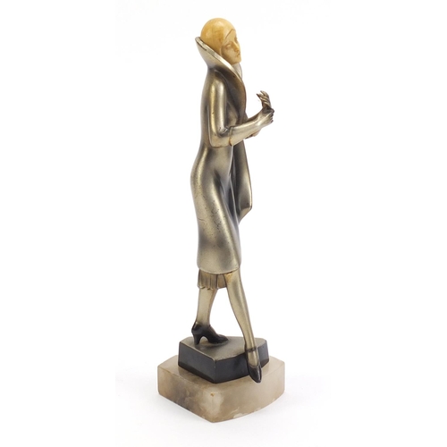 157 - Art Deco bronzed figure of a female with carved ivory head, raised on a shaped onyx base, 25cm high