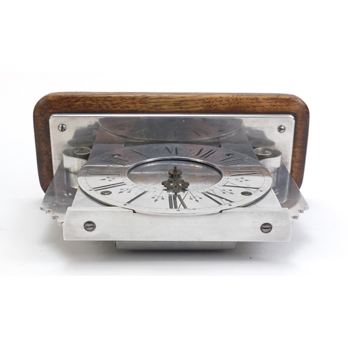 246 - Silvered mantel clock having Roman numerals, engraved with a Dutch landscape, raised on an oak plint... 