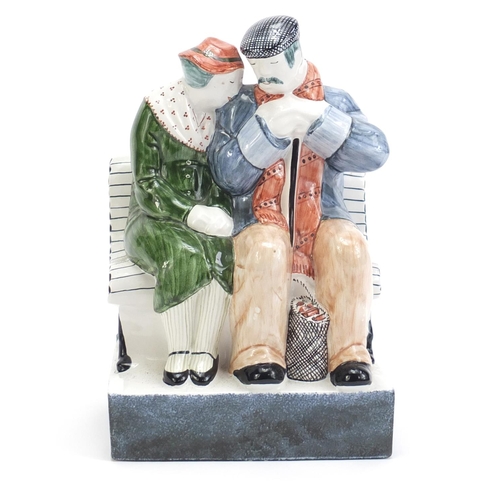 1137 - Rye Pottery group of two figures on a bench, 21cm high