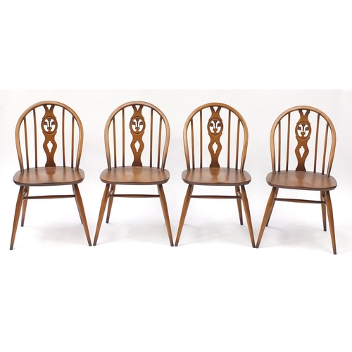 1587 - Ercol elm dining table and four chairs, the table 72cm high x 113cm deep when closed