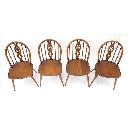 1587 - Ercol elm dining table and four chairs, the table 72cm high x 113cm deep when closed