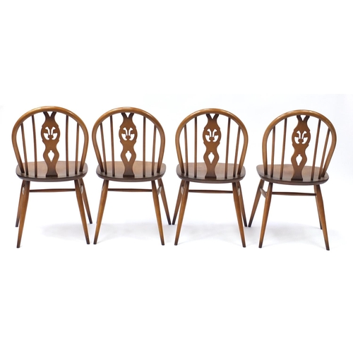 1587 - Ercol elm dining table and four chairs, the table 72cm high x 113cm deep when closed