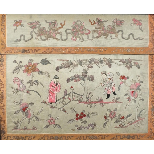 1117 - Chinese silk panel embroidered with two figures amongst flowers in a landscape below two Foo dogs, f... 