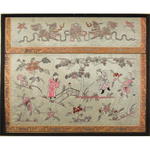 1117 - Chinese silk panel embroidered with two figures amongst flowers in a landscape below two Foo dogs, f... 