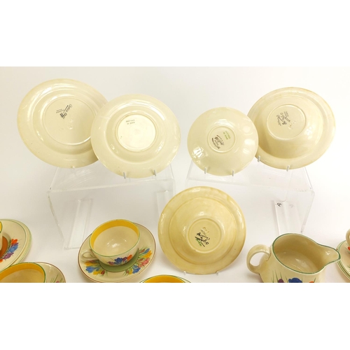 137 - Art Deco Clarice Cliff teaware hand painted in the Crocus pattern including cups, plates and milk ju... 