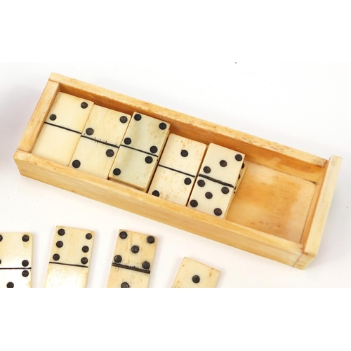 720 - Set of carved bone dominoes with case, each domino 2.5cm x 1.5cm, the case 11cm wide