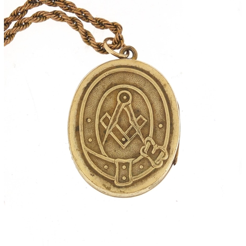 1298 - Masonic interest gold plated locket on a gilt metal long guard chain, 140cm in length