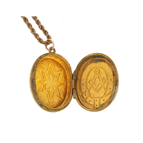 1298 - Masonic interest gold plated locket on a gilt metal long guard chain, 140cm in length