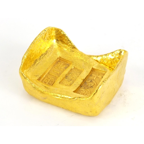 637 - Chinese gold coloured metal ingot, impressed marks, 6cm wide