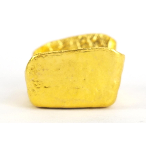 637 - Chinese gold coloured metal ingot, impressed marks, 6cm wide