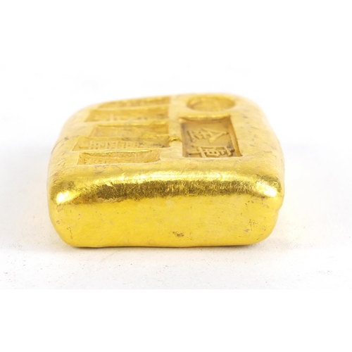 1028 - Chinese gold coloured metal ingot, impressed marks, 5.5cm wide