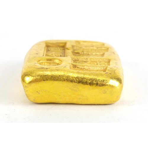 1028 - Chinese gold coloured metal ingot, impressed marks, 5.5cm wide