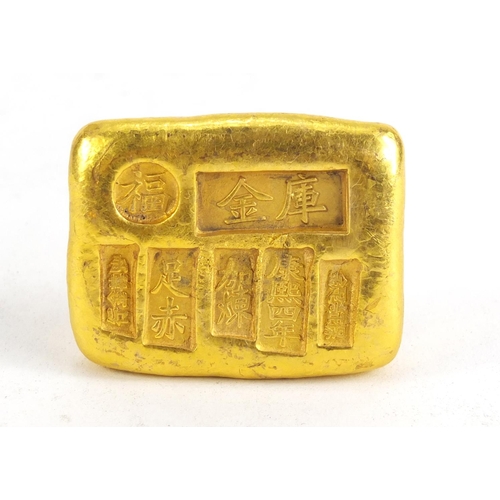 1028 - Chinese gold coloured metal ingot, impressed marks, 5.5cm wide