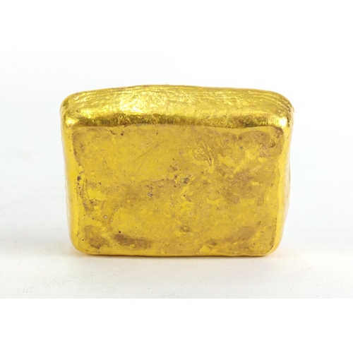 1028 - Chinese gold coloured metal ingot, impressed marks, 5.5cm wide