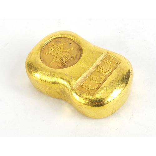 1067 - Chinese gold coloured metal ingot, impressed marks, 5.5cm wide