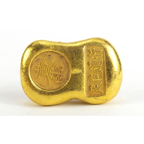 1067 - Chinese gold coloured metal ingot, impressed marks, 5.5cm wide