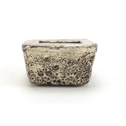 498 - Chinese silver coloured metal ingot, impressed marks, 4cm wide