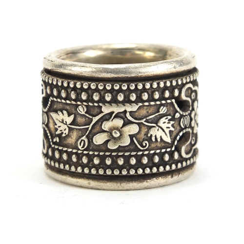 1130 - Chinese silver coloured metal archer's ring with rotating band, 3cm in diameter