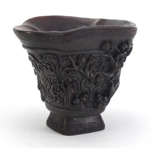 1031 - Chinese libation cup carved with water dragons and flowers, 12.5cm high