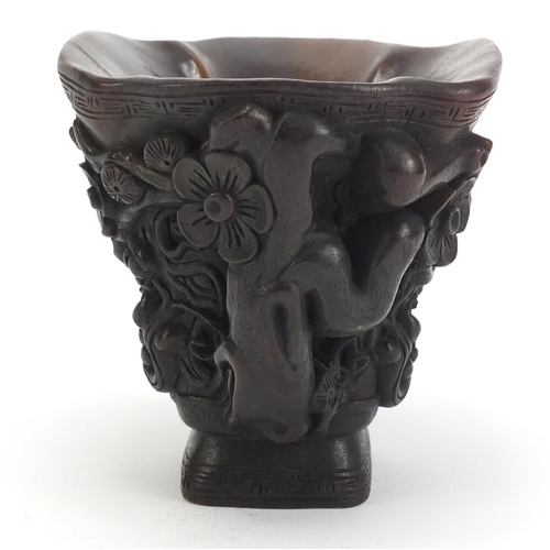 1031 - Chinese libation cup carved with water dragons and flowers, 12.5cm high