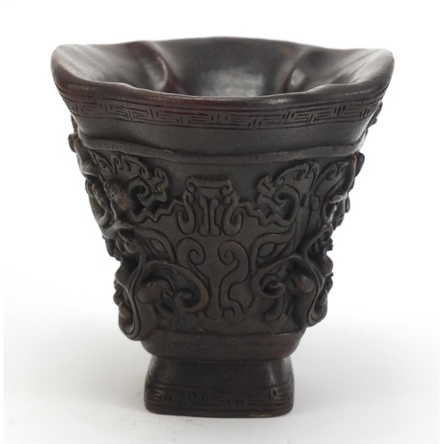 1031 - Chinese libation cup carved with water dragons and flowers, 12.5cm high