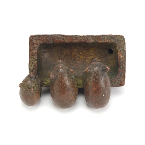 636 - Japanese patinated bronze okimono of three piglets in a trough, impressed character marks to the bas... 