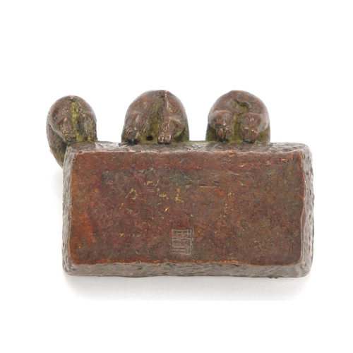 636 - Japanese patinated bronze okimono of three piglets in a trough, impressed character marks to the bas... 