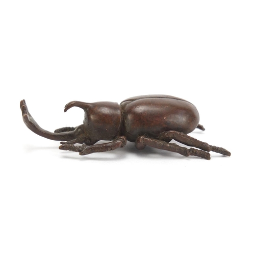 499 - Japanese patinated bronze rhino horn beetle, impressed marks to the base, 7.5cm in length