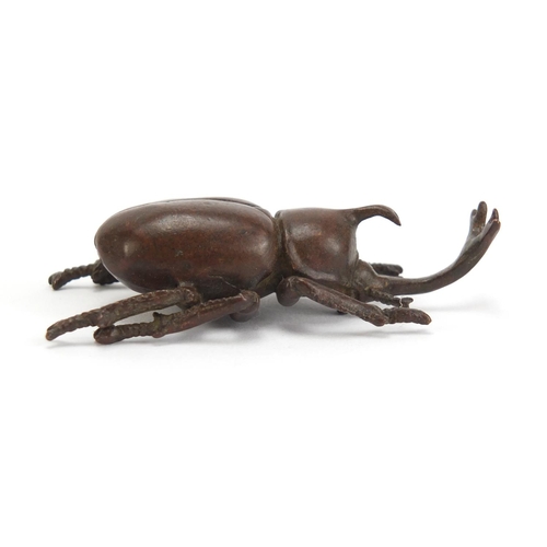 499 - Japanese patinated bronze rhino horn beetle, impressed marks to the base, 7.5cm in length