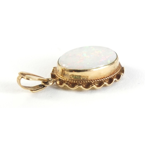 320 - 9ct gold opal pendant, 2.5cm in length, 1.7g