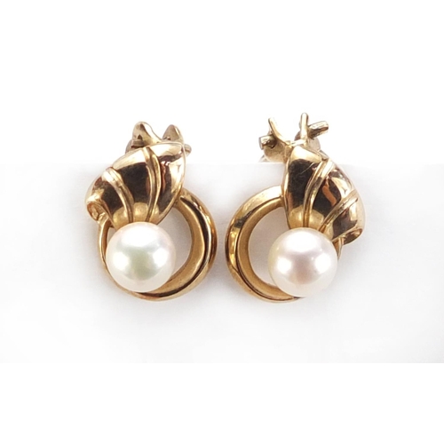 933 - Pair of 9ct gold pearl earrings with clip backs, 1.4cm in length, 3.8 g