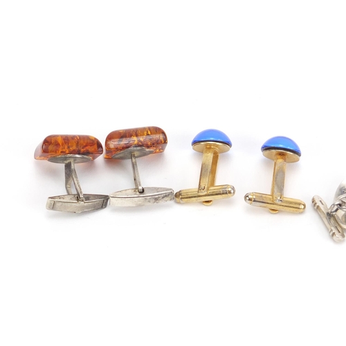 1400 - Four pairs of cufflinks including silver and enamel and amber