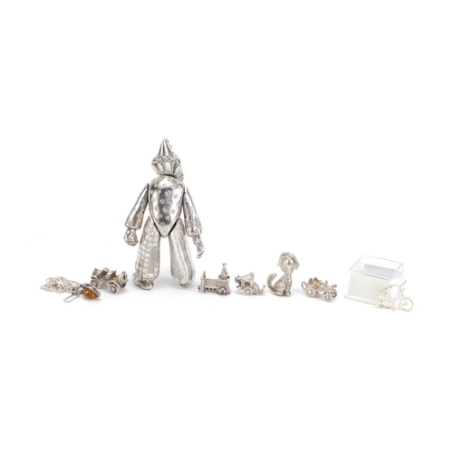 972 - Silver charms, amber pendant and a silver plated articulated clown, 10cm high