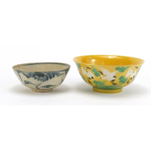 834 - Two Chinese porcelain bowls including a yellow ground example, hand painted with cranes amongst clou... 