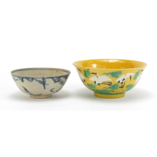 834 - Two Chinese porcelain bowls including a yellow ground example, hand painted with cranes amongst clou... 